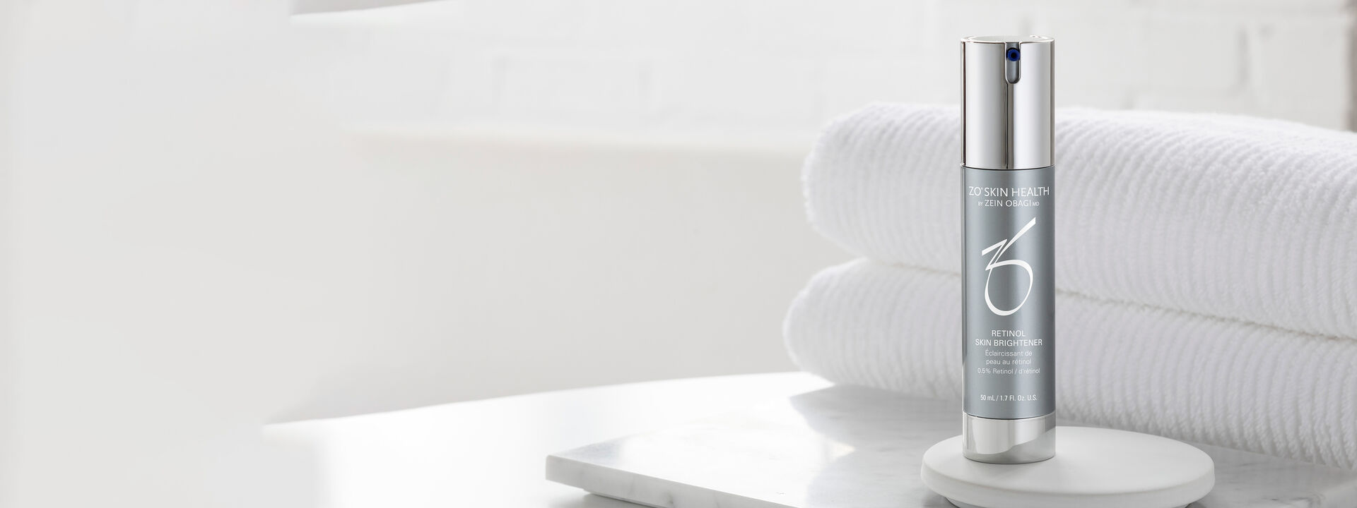 Retinol Skin Brightener in front of folded towels