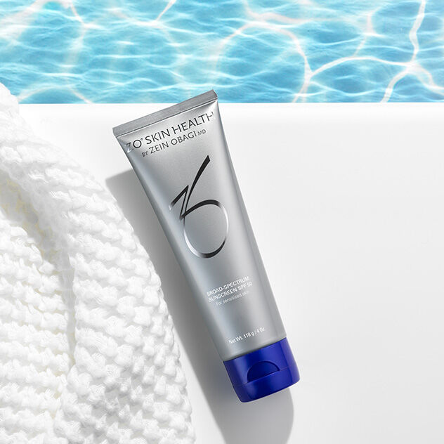 Broad Spectrum Sunscreen beside a pool